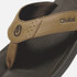 Olukai OluKai Men's Pili Sandal, close-up of tan and black sandal with adjustable strap and logo detail