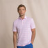 Southern Tide Men's Driver Wild Winds Stripe Polo, a man wearing a pink and white striped polo shirt with a collar, short sleeves, and a fitted style, paired with blue shorts.