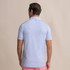 Southern Tide Men's Coastal Breeze Water Way Stripe Polo, back view of a man wearing a blue and white striped polo shirt with a small logo on the back of the collar.