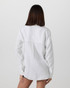 Vuori Women's Trestles Twill Button Up, back view of a woman with straight brown hair wearing a white button-up tencel twill shirt.