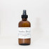 Cahaba Luxury Goods Room Spray, amber glass spray bottle with white label and black cap, labeled Sunday Reset with honeydew melon, cactus rose, and grapefruit scent.