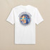 Southern Tide Men's Short Sleeve Guitar Bonfire Tee, white T-shirt with a colorful back graphic of a guitar, palm trees, and a bonfire at the beach, featuring coastal and southern seaside themes.
