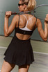 FP Movement Women's Baseline Tennis Dress, athletic woman holding tennis racket on the court.