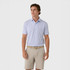 Rhoback Men's The Stars & Carts Performance Polo, a man wearing a stylish short-sleeve polo shirt with a colorful star and cart pattern, paired with beige shorts for a casual summer look.