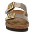 Birkenstock Sandals Birkenstock Sydney Luxe Buckle Sandal, close-up view of the beige double-strap sandal with gold buckles, cushioned footbed, and cork sole.