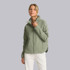 Vuori Women's Canyon Insulated Jacket, a light green insulated outdoor jacket worn by a woman with the collar zipped up.