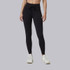 Vuori Women's AllTheFeels Legging, black high-waisted athletic leggings with a drawstring waist and slim fit, paired with white sneakers.