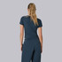 Vuori Women's Pose Fitted Tee, back view of a woman with long blonde hair wearing a navy blue fitted athletic T-shirt and matching navy blue joggers.