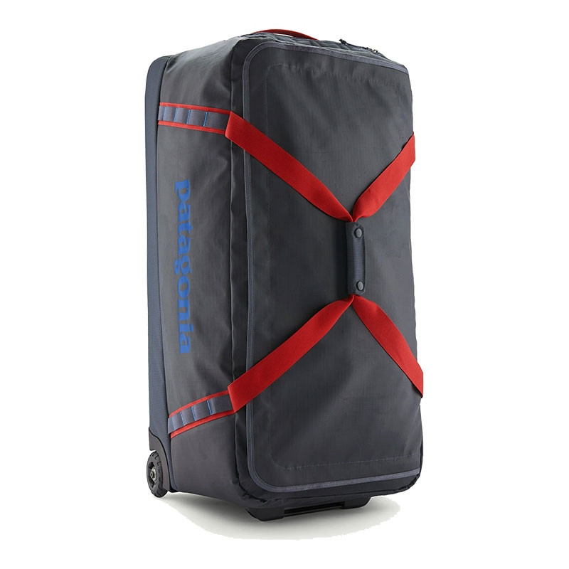 Patagonia Black Hole Wheeled Duffle 100L, a large durable travel duffle with black exterior, red compression straps, and built-in wheels for easy transport.