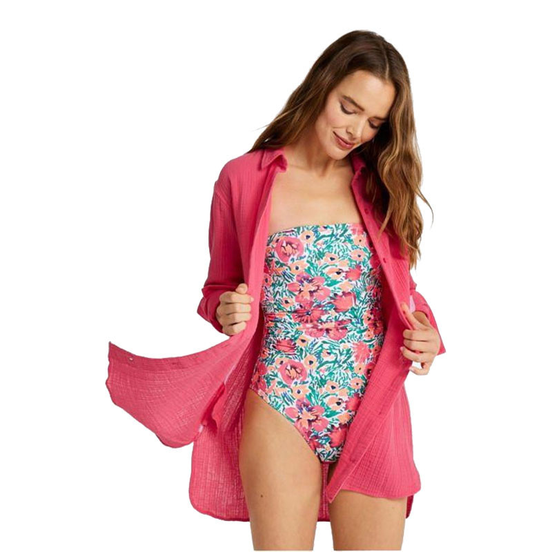 L.L.Bean Women's Cloud Gauze Cover-Up Shirt, a woman wearing a floral one-piece swimsuit layered with a pink gauze cover-up shirt.
