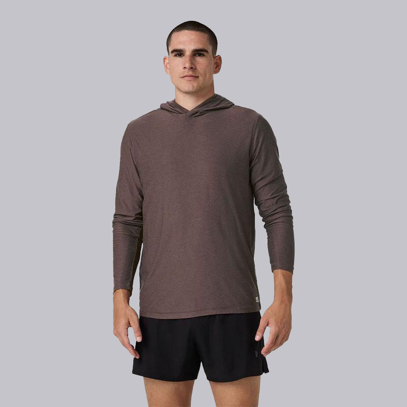 Vuori Men's Strato Tech Hoodie, male model wearing a lightweight, long-sleeve hoodie in brown color with a hood and casual fit.