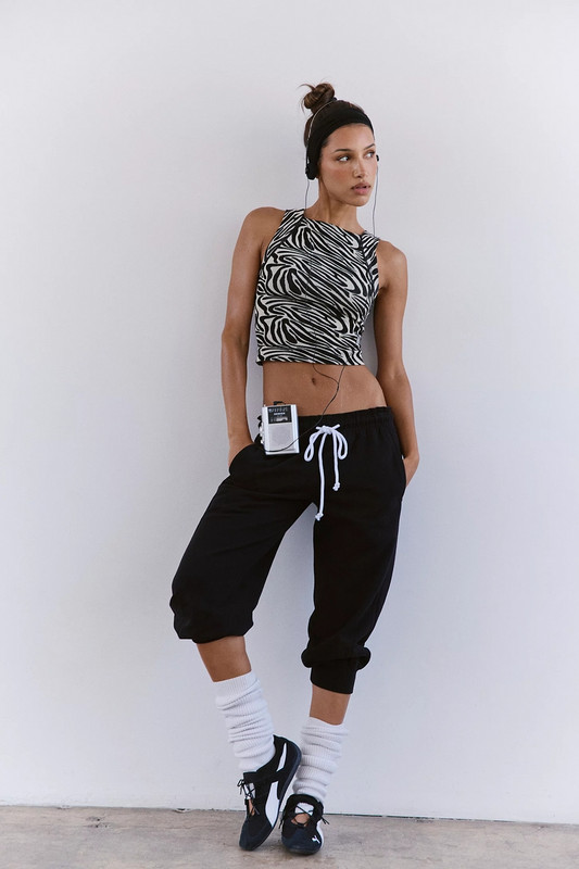 FP Movement Women's Flutter Jogger, black relaxed fit cropped joggers with white drawstring and cuffs.