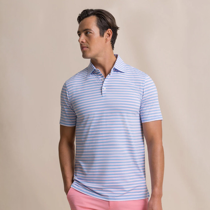 Southern Tide Men's Coastal Breeze Water Way Stripe Polo, a man wearing a blue and pink striped polo shirt.