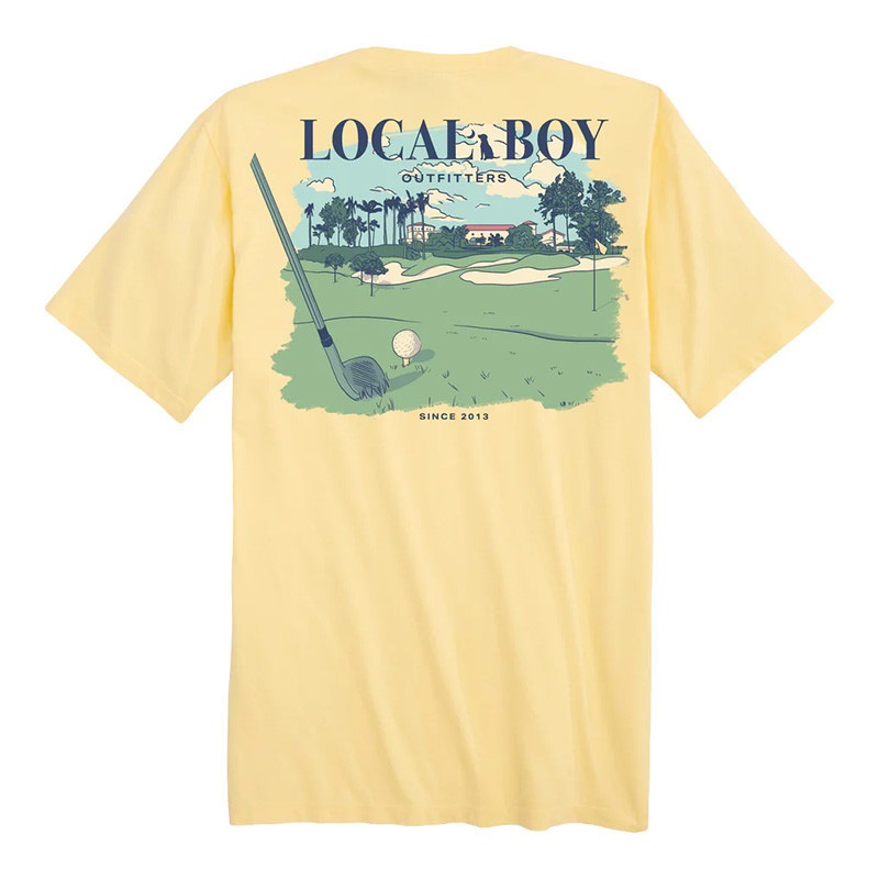 Local Boy 18th Hole SS Tee, yellow golf-themed T-shirt with a graphic of a golf course, golf club, and golf ball.
