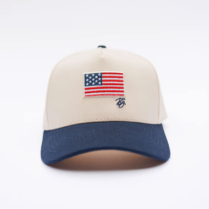 Darling Grey Women's Flag Trucker Hat, Beige and navy blue adjustable baseball cap with American flag embroidery on front.