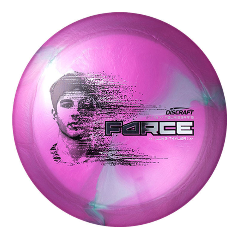 Discraft Disc Golf Discraft 2026 Luke Taylor Tour Series Force, pink and purple disc with a graphic of a woman's face and the word FORCE in bold letters.