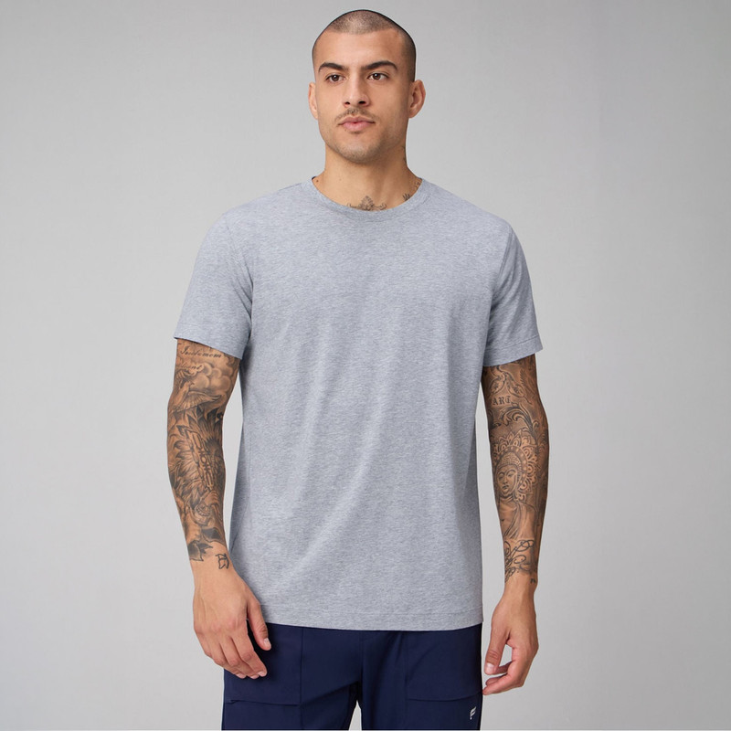 Fabletics Men's 24-7 Tee, light grey casual athletic T-shirt worn by a tattooed male model.