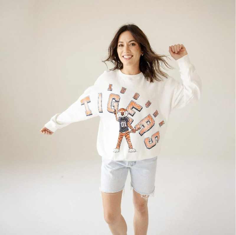 Gameday Social Women's Auburn Bryant Bend Lantern Sleeve Crew, a woman wearing a white tiger graphic sweatshirt with Auburn Tigers logo, in a casual pose.