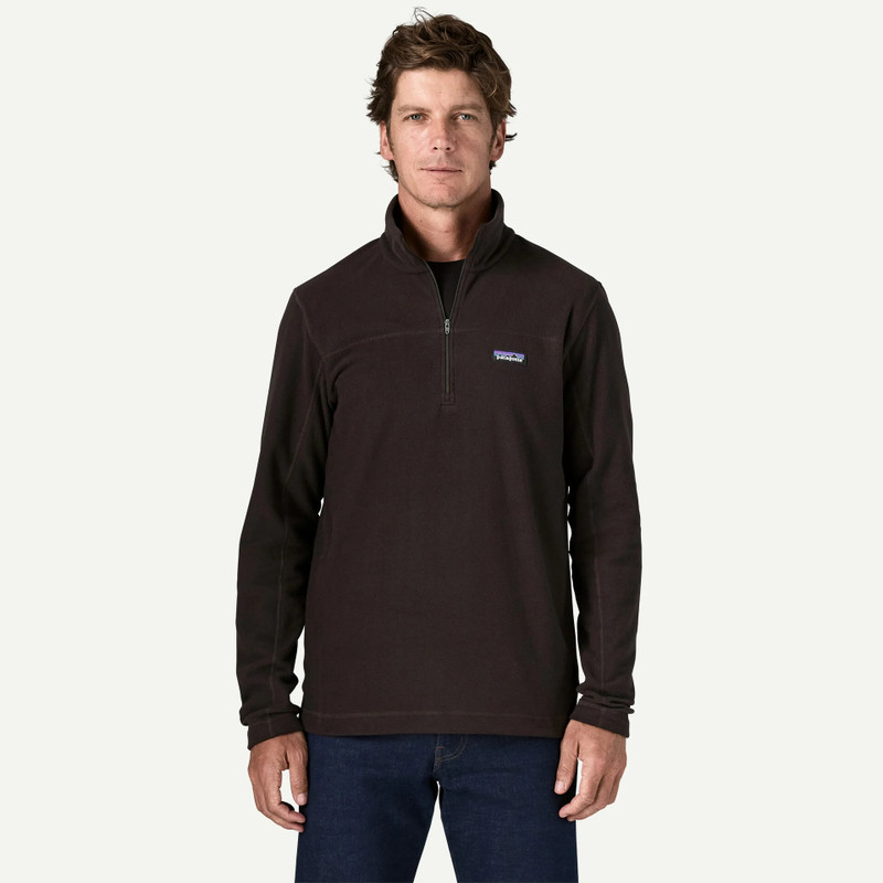 Patagonia Men's Micro D Pullover, model wearing a dark brown quarter-zip fleece pullover with a stand-up collar and Patagonia chest logo