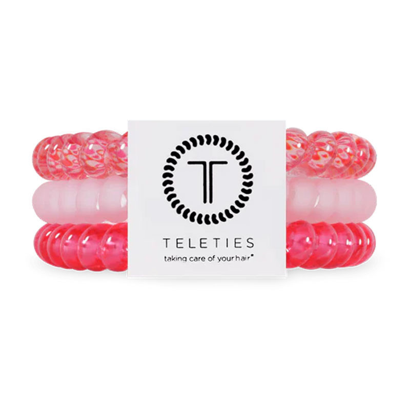 Teleties Large, set of large hair elastics in pink, marbled, and translucent pink colors with a white packaging label featuring the Teleties logo and slogan.