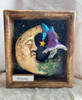 Close-up view of Dreamy highlighting the peaceful moon face, whimsical mushroom, textured details, and handcrafted clay work.