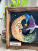 Close-up view of Dreamy highlighting the peaceful moon face, whimsical mushroom, textured details, and handcrafted clay work.