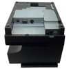A top-down view looking directly at the bottom of the charcoal gray receipt printer. The lower portion features the solid matte black base structure, while the central recessed area houses a silver metal electronics bay. Inside this bay, a line of three ports is visible: a square USB Type-B port, a 9-pin female RS232 serial port, and a circular 3-pin 24V power jack. A separate modular cash drawer port sits in its own recess to the right.