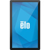 A straight-on, full-front studio shot against a solid white background showing the Elo I-Series 4 Standard 21.5-inch all-in-one touch computer panel rotated into a vertical portrait orientation. The hardware features a retail-hardened black bezel with a thin silver-trimmed outer edge and a glossy, flat protective glass screen surface. The display is illuminated, showcasing a vertical arrangement of the blue and teal geometric polygon graphics layout. Centered perfectly on the screen is the official lowercase "ēlo" corporate brand logo printed in bold white text.