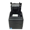 Front view of a black Bixolon SRP-S300 linerless thermal printer with its top cover flipped completely open, revealing the internal mechanics and the paper roller assembly. A clean, white roll of thermal paper is sitting ready inside the paper reservoir stall, and an Energy Star badge is affixed to the lower-left corner.