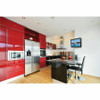 Modern kitchen with glossy red cabinetry, stainless steel appliances, and a black kitchen island with bar stools, featuring a small television mounted on the white wall showing a sailboat scene using the Peerless-AV PA730 wall mount.