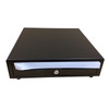 A direct straight-on front view of a closed black matte APG Vasario cash drawer, showing a central keyhole lock and a protective white tape strip covering the horizontal media slots.