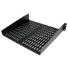An angled perspective view of a StarTech 2U Universal Vented Rack Shelf (CABSHELFV) designed for standard 19-inch server racks.

The image highlights the following structural features:

Construction: A heavy-duty, cold-rolled steel shelf with a matte black powder-coated finish.

Vented Design: The flat surface of the shelf features two large sections of horizontal ventilation slots to promote airflow and prevent equipment from overheating.

Mounting Brackets: The shelf has integrated 2U height side brackets with pre-drilled mounting holes at the front for secure attachment to a server rack or cabinet.

Form Factor: A cantilever (front-mount) design with a solid lip at the back to help keep non-rackmount equipment, such as routers or small switches, in place.

The shelf is shown against a plain white background, emphasizing its industrial build quality and functional design.