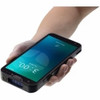 High-angle perspective view of a black Datalogic Memor 30 full-touch mobile computer being held horizontally in a person's hand against a white background. The device is tilted forward, highlighting the rugged top edge which houses a recessed, blue-tinted 2D barcode scanning window and an integrated lanyard loop slot on the corner. The active touchscreen display shows an inverted lock screen layout with a digital clock reading "3:00 PM", while tactile rubberized side buttons are visible along the right edge of the sleek, smartphone-style enterprise terminal.