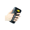 A product shot on a clean white background showing the back panel of a black Datalogic Memor 11 mobile computer being held securely in a person's left hand. A thick, black woven fabric hand-strap runs vertically down the center of the device, stretching over the back of the user's hand to provide an ergonomic grip. The hand-strap features a prominent white "DATALOGIC" logo with its star icon. Near the top of the terminal's rear casing, the camera lens, an LED flash, and a bright yellow rectangular warning or regulatory label are visible.