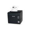An angled side-front view of a dark gray Epson TM-L90II LFC thermal printer resting on a white background, oriented horizontally. The white Epson logo is printed prominently on the front face next to a clear plastic power switch. A sample receipt with text and a cafe logo extends upward from the top paper slot, and a small square "Liner-Free Compatible" sticker is visible on the lower right corner.