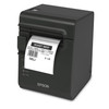 An angled front-facing three-quarter view of a dark gray Epson TM-L90 Plus linerless thermal printer on a white background. A printed white deli barcode label for "ROAST BEEF" with pricing and weight details hangs from the front output slot. The unit displays a white Epson logo on the lower front face, alongside a circular feed button and status indicator icons on the left side panel.