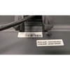 Rear close-up view of a dark gray POSBANK APEXA 12.1-inch customer-facing LCD display casing, focusing on the identification stickers. The main white label lists Model APEXA_12.1 (W) and Serial Number MOJL210602988 above a barcode. A nearby secondary sticker outlines button controls: "Short push : Autocalibration" and "Long push : power ON/OFF".