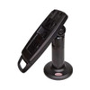 The file ens-flexipole-complete-counter-mount-quick-release-stand-ass30121-side2.jpg shows a three-quarter studio shot of a black ENS FlexiPole payment terminal counter stand, viewed from the opposite side perspective against a plain white background.

The black hardware features a vertical support pole mounted to a circular, flared desk flange, which has a small red and white oval sticker visible near its front edge. Affixed to the adjustable tilt hinge at the peak of the pole is a long, rectangular composite mounting plate tilted upward and back. The face of the mounting plate features open tracks, screw slots, and a molded D-shaped handle loop extending from its bottom edge, designed for quick manual positioning and secure hardware attachment.