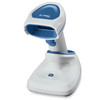 A white Zebra DS8178-HC cordless healthcare barcode scanner fully docked vertically inside its charging presentation cradle, shown against a plain white background. The scanning gun features a bright blue end cap overlayed with a white Zebra brand logo, a matching blue nose cone, and an ergonomic white handle.
