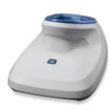 An overhead three-quarter view of the white and blue Zebra healthcare presentation cradle base sitting against a white background. The unit features a clean, curved disinfectant-ready housing, a blue rubberized top cup to receive the scanner head, and a small blue connectivity status button on the lower front face.