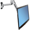 Side angle view of the Ergotron LX Sit-Stand Wall Mount Monitor Arm - Polished Aluminum - Up to 42" - 45-353-026 showing the articulated arm mounted to a wall and fully extended forward to position a large flat-panel monitor with a light blue screen template.