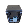 Underside view of the black NCR RealPOS 7199 thermal receipt printer, showcasing the recessed interface panel equipped with a prominent grey RS-232 serial DB9 port module, a USB Type-B port, a USB Type-A port, an RJ12 cash drawer port, and a circular 24V power connector receptacle, isolated on a white background.