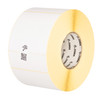 Close-up profile view of a roll of Zebra 4x6 direct thermal labels showing the perforated edges between white labels, a 3-inch core branded with the Zebra logo, and yellow label liner backing.