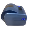 Right side profile view of the dark grey Honeywell PC43d desktop label printer, highlighting the curved clamshell cover design, a clear media viewing window on top, and a bright blue latched release switch on the side.