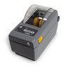 Zebra ZD411d desktop label printer angled left view displaying side latch, control interface, and clear media compartment cover.