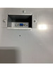 Close-up view of the recessed bottom-exit interface port connector on the metal underside of the M-S cash drawer unit.