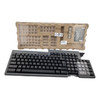Straight-on front view of an iron gray Toshiba POS keyboard featuring a standard QWERTY layout and clear keycap covers on the right-side numeric keypad, set in front of its cardboard packaging tray.