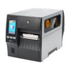 Three-quarter angle view of the closed Zebra ZT411 industrial printer showing its metal frame, front touchscreen, and clear media viewing window on the side door.