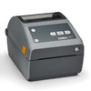 Angled side view of the Zebra ZD621 desktop barcode label printer in gray and dark gray, highlighting the compact profile, control panel, clear media window, and orange release latch.