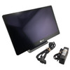 Angled front view of the NCR RealPOS PX15 touchscreen terminal with AC power adapter and power cord.
